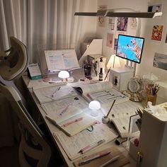 the desk is cluttered with papers, pens and other things to do on it