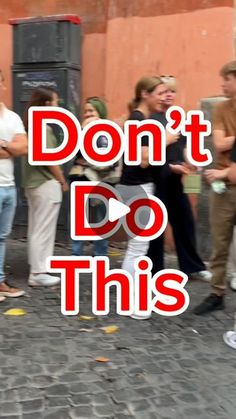 a group of people standing around each other on a brick road with the words don't do this