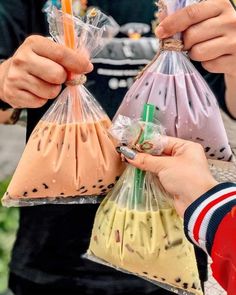 two people holding up bags filled with food and one person is holding a pencil in their hand