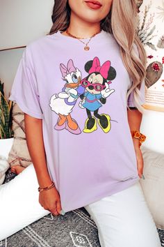 Our most popular designs pressed on a mineral wash, boyfriend fitting comfort tee. Don't see the color option you want? Select white then type the name of the color you want in the space provided. Cute Purple Relaxed Fit T-shirt, Casual T-shirt With Character Print, 90s Inspired Funny Print T-shirt, Cartoon Shirt Design, Minnie And Daisy, Disney Bound Outfits Casual, Daisy Vintage, Disney Bound Outfits, Expressive Fashion