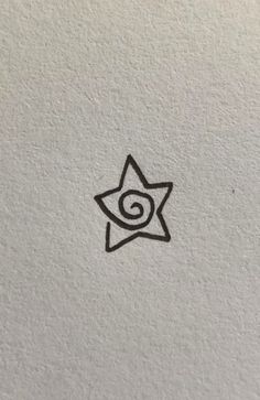 a black and white drawing of a star with a spiral in the middle on a wall