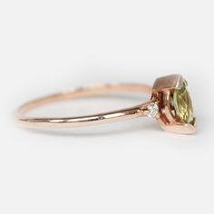 Engagement Ring Details 14k Solid Rose Gold (Also available in White and Yellow Gold, Please select at checkout) 1.5mm (Approximate Band Width) Natural Peridot (Center Stone) Marquise 6X3mm (Center Stone Dimensions) 0.27 Carats (Average Center Stone Weight/ 3 Pcs.) Surrounding Diamond Details White Diamonds 0.05 Carats (Total Diamond Weight/ 2 Pcs.) SI-H (White Diamond) Brilliant Cut Ring can be resized from 3-10, Metal can be made in 14, 18K/ White, Yellow and Rose Gold. For custom order this r Peridot Engagement Ring, Peridot Engagement Rings, Gold Leaf Rings, Beautiful Wedding Bands, Leaf Engagement Ring, Branch Ring, Detailed Engagement Ring, Marquise Ring, Chevron Ring