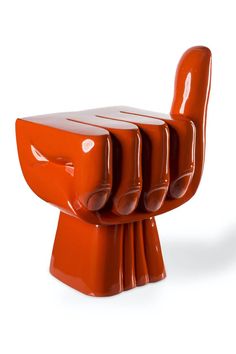 three orange chairs stacked on top of each other