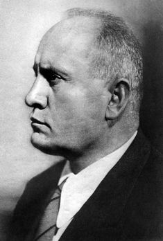 an old black and white photo of a man in a suit with a serious look on his face