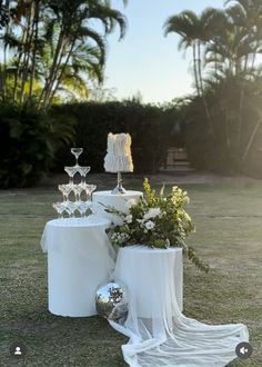 the table is set up with champagne glasses and flowers