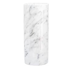 the white marble vase is on display against a white background and has a black lid