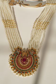 Step into the realm of timelessness with the "Inza - Mala Necklace & Tikka Set." This set embodies distinct style, intricacy, and craftsmanship reminiscent of a bygone era, adding a touch of enchantment to your ensemble.Adorn yourself with charisma as you wear this talismanic set adorned with ethereal stones and the grace of pearl moti, all while radiating the traditional and aesthetic identity. This set includes a long mala necklace and a pair of stunning earrings, each designed to capture the