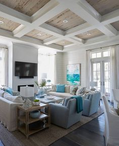 a living room filled with lots of furniture next to a fire place in a house