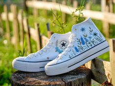 🌸 Hand-Embroidered Floral Converse Wedding Shoes - Perfect for Brides and Bridesmaids.  Are you looking for the perfect blend of comfort and style for your wedding day? Our hand-embroidered floral Converse wedding shoes are the ideal choice for brides and bridesmaids who want to add a unique touch to their special day. Each pair is meticulously crafted with love, featuring beautiful floral embroidery that makes every step down the aisle unforgettable. 📌Key Features: Material: High-quality canvas with hand-embroidered floral designs Sizes: Available in all standard sizes Colors: Classic white Converse with multicolored floral patterns Style: Low-top and high-top options available Why You'll Love These Shoes: Unique Design: Each pair is one-of-a-kind, with intricate floral embroidery that Embroidered Converse High Tops, Floral Converse, Converse Wedding, Baskets Converse, Converse Wedding Shoes, Embroidered Sneakers, Thoughtful Wedding Gifts, Embroidered Converse, Wedding Converse