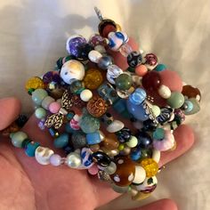 a person holding a bunch of beads in their hand