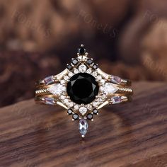 a black and white diamond ring sitting on top of a wooden table