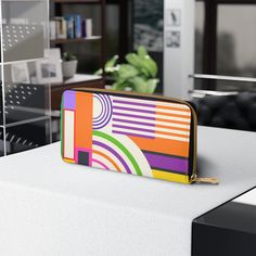 Designed with love and adorned with a colorfully bold abstract bauhaus design, our zipper wallet is made from cruelty-free faux leather, so you can flaunt your unique style without compromising your values! Inside the zipper closure, you'll find pockets designed to hold your cash, credit cards, coins, and checkbook, ensuring your valuables are secure while you are free to go where your carefree spirit takes you! *Note that this item prints and ships from our overseas production partner in China, Modern Multicolor Wallets For Everyday Use, Modern Multicolor Rectangular Wallets, Trendy Multicolor Wallets With Interior Card Slots, Modern Rectangular Wallets With Zipper Closure, Trendy Multicolor Rectangular Wallets, Retro Multicolor Wallets As Gifts, Retro Multicolor Travel Wallet, Trendy Multicolor Wallet With Zipper Closure, Trendy Multicolor Wallets With Zipper Closure