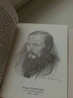 an old photo of a bearded man with long hair and beards is shown in the open book