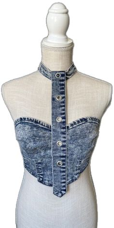 a mannequin wearing a denim top with buttons on the front and back side