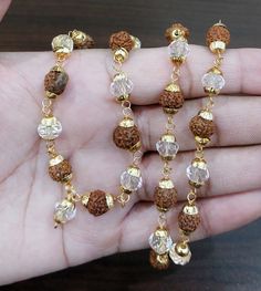 "Beads Size - 6 mm To 8 mm Rudraksha Face - 5 Face (Mukhi) Mala Length Size - 30 cm (Approx.) Style Neck Wear Around Neck For Yoga & Meditation Total No. Of Beads In Mala - 40 Beads Rudraksha Origin - Nepal 5 mukhi Rudraksha represents Lord \"Rudra Kalagni\" which symbolizes the 5 forms of Lord Shiva. This auspicious rudaksha helps awaken one's higher self means \"Upa Guru\" and through that to God.  Hence it is the most widely worn bead by students and sages since ancient times.  The planet associated with 5 mukhi rudraksha is Jupiter. Hence, 5 mukhi is associated with learning, developing one's own uniqueness. It is also associated with optimism and growth ((including mental and spiritual growth)." Lord Rudra, 5 Mukhi Rudraksha, Rudraksha Jewelry, Happy Woman Day, Rudraksha Mala, Rudraksha Beads, Gold Bride Jewelry, Gold Work, Bride Jewellery