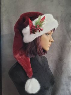 This hat is made from an ultra soft, plush fur in a rich cranberry red. It is a longer, stocking style hat that is over two feet long from the brim to the ball and is trimmed with a snowy white trim. This hat will fit a 22 to 24 inch head and it is available on it's own, or with a cluster of holiday berries and snow kissed pine that are tied with a ribbon and sewn onto the hat. If you need special sizing, message me. Custom orders are welcome. Red Adjustable Holiday Hat, Adjustable Curved Brim Holiday Hats, Adjustable Brimmed Hat For Holiday, Adjustable Hat With Curved Brim For Holidays, Adjustable Curved Brim Hat For Holiday, Adjustable Curved Brim Hat For Holidays, Adjustable Christmas Cap, Adjustable Holiday Costume Hats, Adjustable Red Hats For Holiday