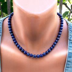 Add a touch of elegance to your ensemble with this exquisite Lapis Lazuli Necklace. Featuring beautiful 8mm Lapis Lazuli beads in varying shades of blue, this stunning necklace exudes timeless beauty and sophistication. Each bead is meticulously strung on durable steel wire and finished with a secure clasp, ensuring both style and durability. Elevate your look with this captivating blue gemstone jewelry that is perfect for any occasion. Necklace length 18 Inches + 2 in Extender Difference in colors ------------------------------ Due to the different settings on monitors and displays, the colors may differ from those you see on your screen. The pictures were taken outside in natural sunlight and there may be a difference in color in room light. ---------------------------------------------- Lapis Necklace, Thoughtful Gifts For Her, Lapis Lazuli Necklace, Lapis Lazuli Beads, Chain Extenders, Blue Lapis, Natural Sunlight, Timeless Gifts, Necklace Blue