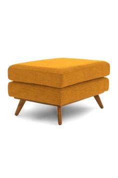 an orange ottoman with wooden legs on a white background