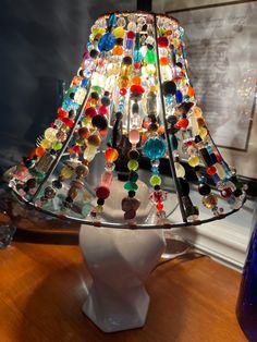 a lamp made out of glass beads on a table