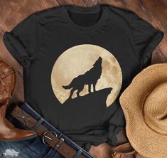 Wolf shirt. Wolf shirt for women. Wolf shirt for men. Wolf lovers shirt. Animals lovers shirt. Wildlife lovers shirt. Wolf With Moon shirt. Wolf cute shirt. Wolf cool design. Suitable outfit for women, men, girls, boys, wolf lovers on holiday, birthday.  🌟 Welcome to SOUQUSA4U! We're excited to bring you premium, ethically crafted cotton T-shirts designed for both comfort and style. Every shirt is made with care and attention to detail, tailored just for you. 📏 PRODUCT INFORMATION & SIZING: Please refer to the Size chart in the images above to find your perfect fit. 🛒 HOW TO PLACE YOUR ORDER: Choose your preferred T-shirt size and color. Select the quantity you want. Click "Add to Cart." For multiple items, simply return to the listing and repeat the process. 🚚 PRODUCTION & SHIPPING: W Wolf Cute, Moon T Shirt, Wolf Shirt, Moon Shirt, Cute Shirt, Holiday Birthday, Shirt For Women, Wolves, Cute Shirts