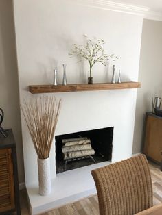 a living room with a fire place and wicker chairs