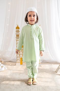 Adorable, made-to-order kurta for infant, toddler and kid boys! Available for Father and Son! Kurta ➤ Breathable and easy-to-wash cotton fabric ➤ Loop buttons that open easy (there are clasps on the back!) ➤ No-itch collar and sleeves ➤ Wide neck to easily fit over baby's head Pajama / Pant / Trouser ➤ Breathable and easy-to-wash cotton fabric ➤ White to match with several kotis, kurtas and occasions ➤ Stretchable elastic waistband Choti Koti kurtas are made without a nehru collar for our smalle Festive Cotton Sherwani With Naqshi, Festive Cotton Sherwani With Naqshi Embroidery, Dabka Pant Set For Eid, Dabka Embellished Pant Set For Eid Festive, Pista Green Cotton Wedding Set, Pista Green Cotton Churidar For Eid, Pista Green Sets For Puja, Festive Cotton Sherwani For Eid, Traditional Festive Sets With Naqshi Detailing