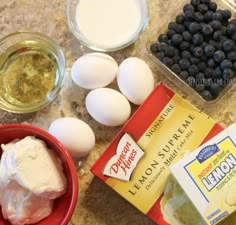 eggs, yogurt and blueberries are on the counter next to other ingredients