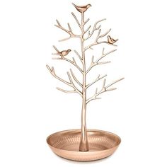 a metal tree with two birds on it in a bowl that is filled with water