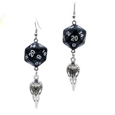 For Raven Queen worshippers who don't want to wear our huge and heavy (but very cool) raven earrings, we also offer this smaller, lighter (but still very cool) version. Each has a pearl black D20. Beneath the dice hang silvery raven skull charms. These would be a perfect accessory for someone playing a member of the shadar-kai or a cleric that worships the Raven Queen. A great gift for players of D&D, Pathfinder, and other tabletop RPGs -- or for anyone who wants to geek out with a fun and myste The Raven Queen, Raven Earrings, Shadar Kai, Queen Character, Character Earrings, Dice Earrings, Raven Queen, Raven Skull, Bird Skull