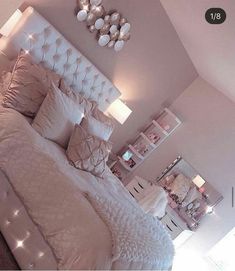 a white bed sitting in a bedroom on top of a carpeted floor next to a window