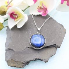 "A striking Labradorite Circle Pendant in Sterling Silver. Shape: Circle Cabochon Size: 20mm x 20mm (28mm length including bail)  Material:  925 Sterling Silver, Labradorite Colour: Blue Chain: Complimentary 18\" rope chain (pictured) included.  Upgrades available at check out Postage: Free to the UK, fee for international tracked and signed Gemstone meaning: A stone of transformation providing strength and perseverance through times of change.  Birthstone: February or March (non-traditional) Se Sterling Silver Cabochon Gemstone Round Pendant, Large Round Sterling Silver Gemstones, Large Round Labradorite Gemstones, Large Round Labradorite Necklaces, Round Labradorite Necklace With Large Stone, Blue Round Labradorite Jewelry, Large Labradorite Stone Necklaces, Nickel-free Round Labradorite Necklace, Sterling Silver Round Cabochon Gemstones