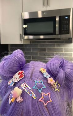 a woman with purple hair has many clips in her hair and is wearing a star shaped headband