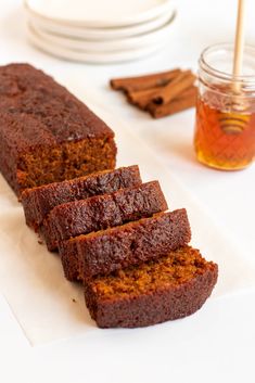 slices of chocolate cake sitting on top of a white plate next to a glass of tea