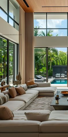 a living room filled with furniture and large windows