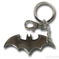 a metal batman keychain with the bat symbol on it's front and back