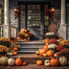 pumpkins and gourds on the front steps of a house with fall decorations