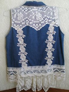 a blue jean vest with white lace on it