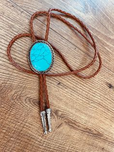 This awesome bolo tie has a southwestern design and agate centerpiece. The cord is genuine brown leather. Our bolos pair nicely with many of our belt buckles! They make wonderful gifts. The western bolo tie rope length is 40'' ; charm agate stone pendant size is 2'' x 1 1 /2''