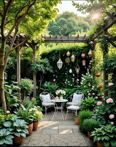 an outdoor patio with chairs and tables surrounded by greenery, plants and flowers on either side