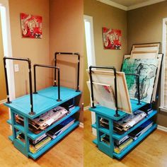 two blue tables with art on them in the middle of a wooden floored room