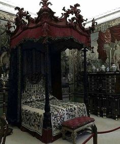 an ornate bed is in the middle of a room