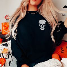 "Skull Sweatshirt, Glitter Skull Sweatshirt, Skull Sweater, Spooky Sweatshirt, Halloween Sweatshirt, Skeleton Sweatshirt, Skull Shirt, Gothic Our spooky Halloween skull sweatshirt makes the perfect addition to your wardrobe this Halloween. The bats are made of a high quality black or silver glitter that won't fall off or leave glitter anywhere, not even after washing. If you have any questions feel free to reach out and I am happy to help. PLEASE NOTE: THIS SWEATSHIRT IS A UNISEX FIT SO IT DOES Luxury Skull Print Crew Neck Top, Luxury Crew Neck Top With Skull Print, Cheap Crew Neck Shirt With Skull Print, Glitter Skull, Nursing Sweater, Spooky Sweatshirt, Skeleton Sweatshirt, Skull Sweatshirt, Skull Sweater