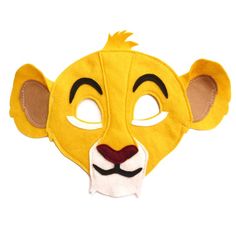 a yellow lion mask with ears and eyes