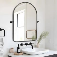 a bathroom sink sitting under a large mirror