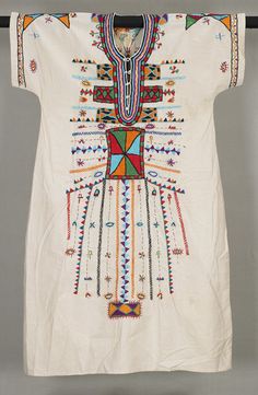 Africa | Wedding dress from the Bedouin women of Egypt | Cotton; embroidered || Traditionally, embroidered dresses are an essential part of a young Bedouin woman's marriage trousseau. Before puberty she creates at least seven embroidered dresses, one for each day of the week of her wedding, which is punctuated by a series of rituals and ceremonies. On the third day, the bride dons a white dress elaborately embroidered with a multitude of motifs in auspicious colors. Africa Wedding Dress, Egyptian Clothes, Africa Wedding, Women Marriage, Embroidered Dresses, Mode Abaya, African Textiles, Folk Costume, Estilo Boho