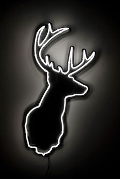 a neon sign with a deer's head on it