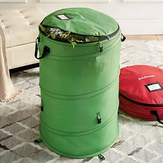 two round storage bags sitting on the floor next to each other in front of a couch