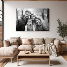 a black and white photo of a family on the wall above a couch in a living room