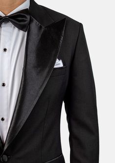 Crafted from a luxurious sharkskin weave wool, the Liberty Black Tuxedo is a sophisticated, statement-making formalwear option. Wide peak lapels in a single button configuration stand out from typical tuxedo styles. Dress to impress with this high-end, premium garment – a modern blend of elegance and refinement. Black Tuxedo With Hidden Button Closure For Party, Tuxedo Suits For Black-tie Gala Events, Luxury Evening Blazer With Lapel Collar, Tuxedo Blazer For Black-tie Gala Events, Notch Lapel Tuxedo For Black-tie Gala Events, Classic Black Tuxedo For Gala, Fitted Tuxedo With Hidden Button Closure For Parties, Bespoke Fitted Evening Suits, Black Tie Tuxedo Blazer With Hidden Button Closure