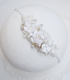 Beautiful ivory headband. Headband decorated with pearls. Application size approx. 2.5 cm x 10 cm. The application is available on a nylon elastic band or elegant elastic lace. The headband is perfect for baptisms, birthdays and photo sessions. White Crown Headpieces As Gift, Handmade White Headpieces For Gifts, Handmade White Headpieces As Gift, Handmade White Headband Headpiece, White Handmade Headband For Parties, White Flower-shaped Hair Accessories With Matching Headband, Cream Baptism Headband Hair Accessory, White Floral Hair Accessories With Matching Headband, Cream Headband For Baptism